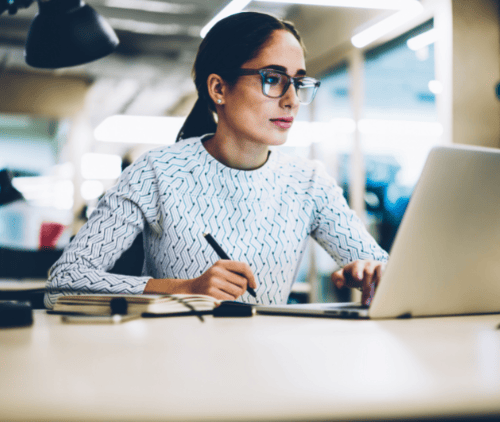 Woman researching data management best practices on her laptop