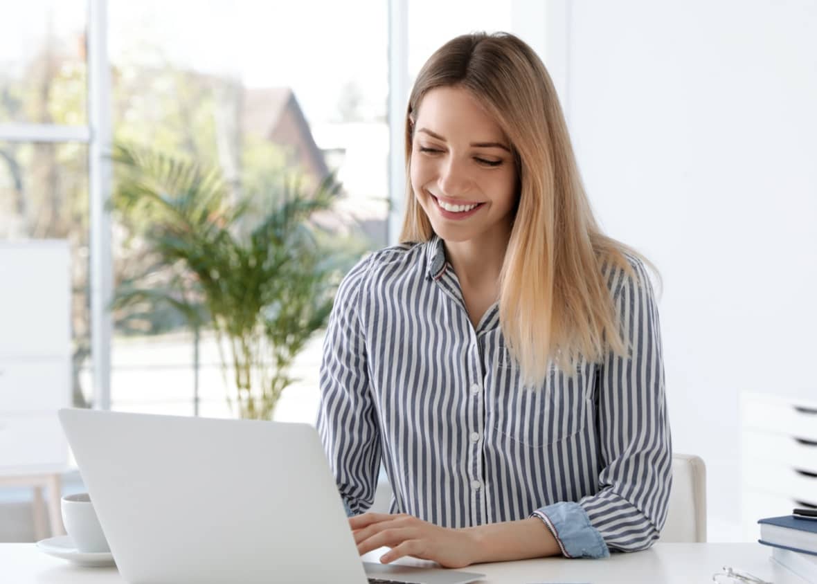 Olive employee using data to find success on her laptop